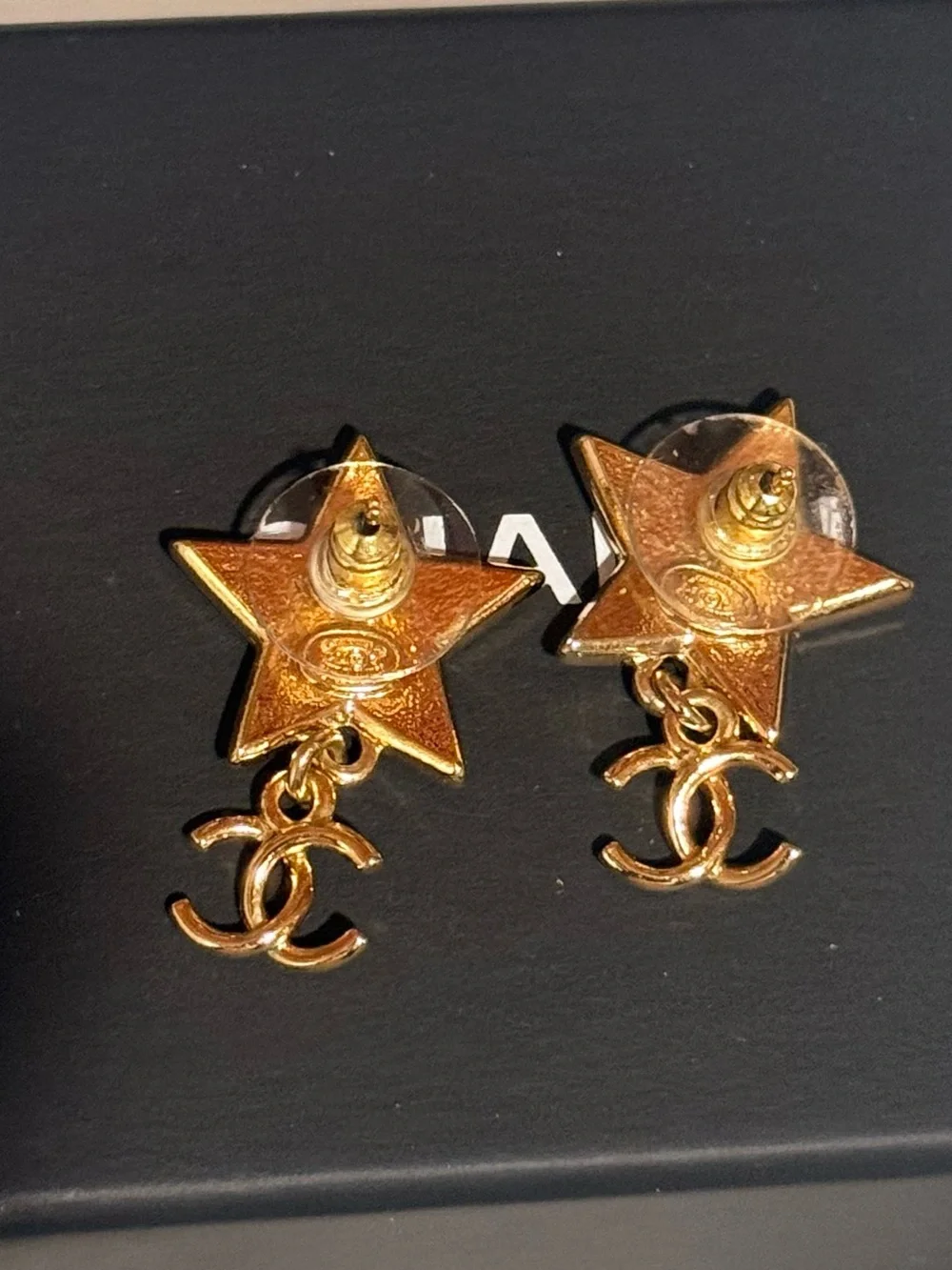 CHANEL Gold Star Drop Earrings with Black Enamel